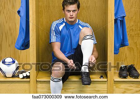 Young soccer player tying shoe, portrait View Large Photo Image Stock Photo - Young soccer player tying shoe, portrait. Fotosearch