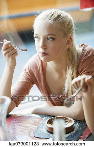 Young woman eating dessert View Large Photo Image Stock Image - Young woman eating dessert. Fotosearch