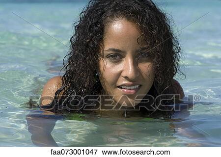 Stock Photo - Young woman in water, portrait. Fotosearch