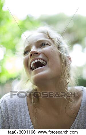Young woman laughing, portrait View Large Photo Image Stock Photograph - Young woman laughing, portrait. Fotosearch