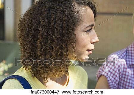 Young woman listening attentively View Large Photo Image Stock Photo - Young woman listening attentively. Fotosearch