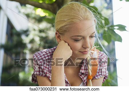 Young woman looking down in thought, portrait View Large Photo Image Stock Image - Young woman looking down in thought, portrait. Fotosearch