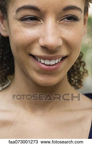 Young woman smiling, portrait View Large Photo Image Stock Image - Young woman smiling, portrait. Fotosearch