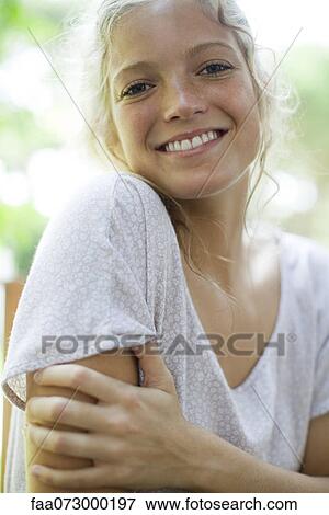 Stock Photo - Young woman smiling, portrait. Fotosearch