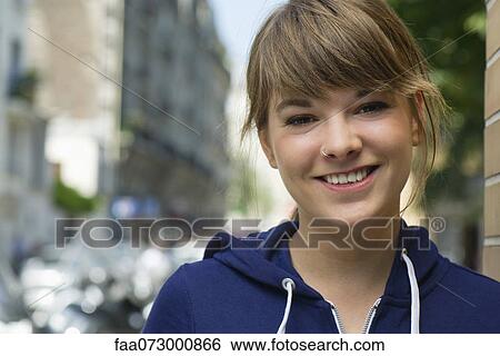Young woman smiling, portrait View Large Photo Image Stock Photograph - Young woman smiling, portrait. Fotosearch