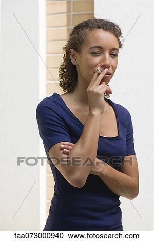 Young woman smoking cigarette View Large Photo Image Stock Image - Young woman smoking cigarette. Fotosearch