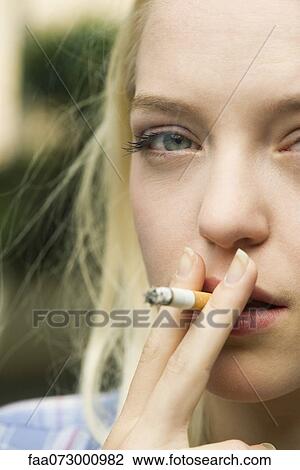 Young woman smoking cigarette View Large Photo Image Stock Image - Young woman smoking cigarette. Fotosearch