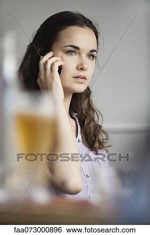Young woman using cell phone View Large Photo Image Stock Photograph - Young woman using cell phone. Fotosearch