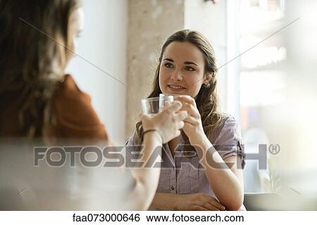 Young women raising glasses View Large Photo Image Stock Photograph - Young women raising glasses. Fotosearch