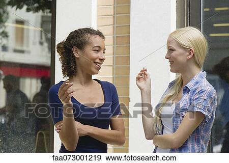 Young women taking cigarette break View Large Photo Image Stock Photo - Young women taking cigarette break. Fotosearch
