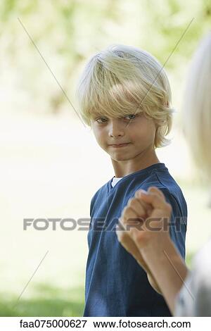 Boy bumping fists with friend, cropped View Large Photo Image Stock Photo - Boy bumping fists with friend, cropped. Fotosearch
