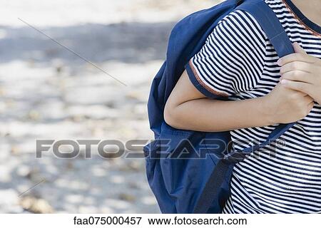 Boy carrying backpack, cropped View Large Photo Image Stock Photo - Boy carrying backpack, cropped. Fotosearch
