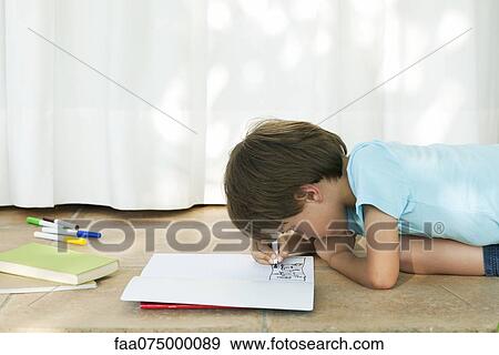 Boy drawing in notebook View Large Photo Image Stock Photo - Boy drawing in notebook. Fotosearch