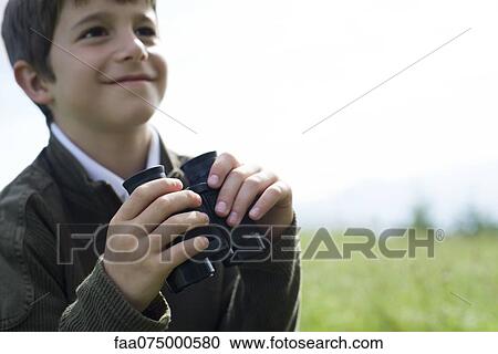 Boy holding binoculars, focus on hands View Large Photo Image Stock Image - Boy holding binoculars, focus on hands. Fotosearch
