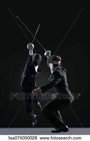Businessmen fencing View Large Photo Image Stock Photo - Businessmen fencing. Fotosearch