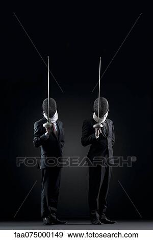Businessmen with fencing masks holding up fencing foils View Large Photo Image Stock Photo - Businessmen with fencing masks holding up fencing foils. Fotosearch
