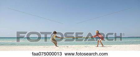 Children playing tug-of-war with bamboo at the beach View Large Photo Image Stock Image - Children playing tug-of-war with bamboo at the beach. Fotosearch