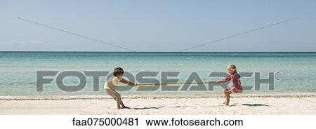 Children playing tug-of-war with bamboo at the beach View Large Photo Image Stock Image - Children playing tug-of-war with bamboo at the beach. Fotosearch