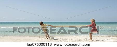 Children playing tug-of-war with bamboo at the beach View Large Photo Image Stock Photograph - Children playing tug-of-war with bamboo at the beach. Fotosearch
