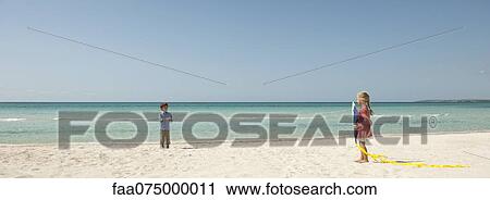 Children playing with kite at the beach View Large Photo Image Stock Image - Children playing with kite at the beach. Fotosearch