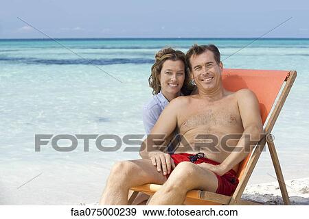 Stock Photo - Couple at beach, portrait. Fotosearch