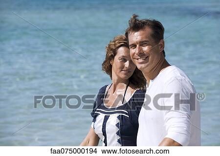Couple at beach, selective focus View Large Photo Image Picture - Couple at beach, selective focus. Fotosearch
