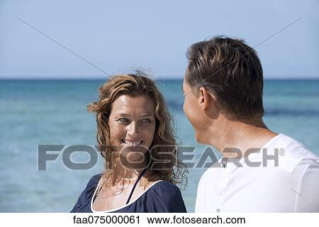 Stock Image - Couple at beach. Fotosearch
