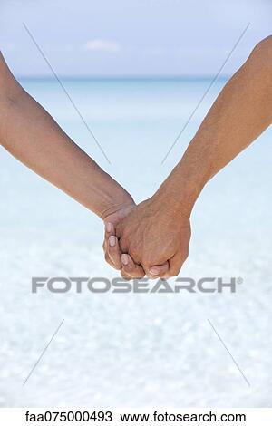 Couple holding hands, cropped View Large Photo Image Stock Image - Couple holding hands, cropped. Fotosearch