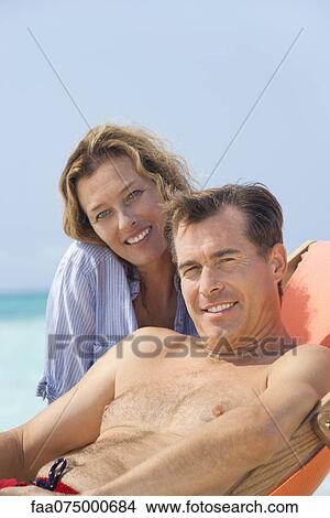 Couple spending time at beach, portrait View Large Photo Image Picture - Couple spending time at beach, portrait. Fotosearch
