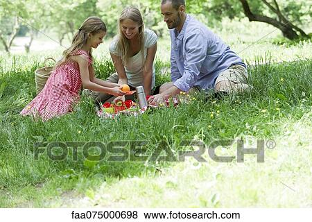 Family enjoying picninc outdoors View Large Photo Image Stock Photo - Family enjoying picninc outdoors. Fotosearch