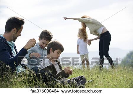 Picture - Family spending time together outdoors. Fotosearch