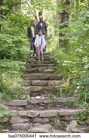 Family walking down stone steps in woods View Large Photo Image Stock Image - Family walking down stone steps in woods. Fotosearch