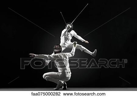 Fencers fencing, one fencer jumping in air View Large Photo Image Stock Image - Fencers fencing, one fencer jumping in air. Fotosearch