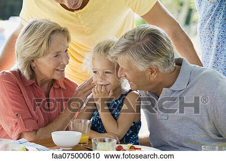 Stock Image - Girl and grandparents, cropped. Fotosearch