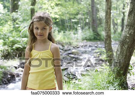 Girl by stream in woods, portrait View Large Photo Image Stock Image - Girl by stream in woods, portrait. Fotosearch