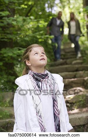 Girl in woods, looking up View Large Photo Image Picture - Girl in woods, looking up. Fotosearch
