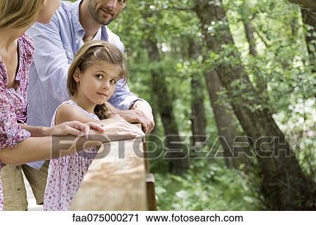 Stock Image - Girl spending time with parents outdoors, cropped. Fotosearch