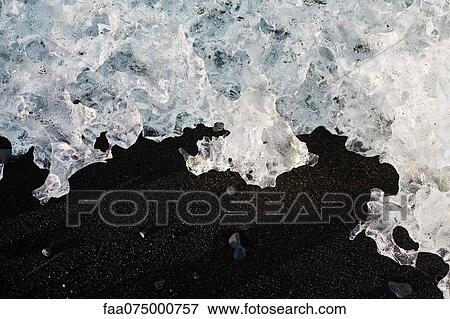 Stock Photo - Glacial ice washed up on beach, Jokulsarlon glacial lagoon, Iceland. Fotosearch