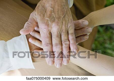 Hands of senior woman and little girl stacking View Large Photo Image Stock Photo - Hands of senior woman and little girl stacking. Fotosearch