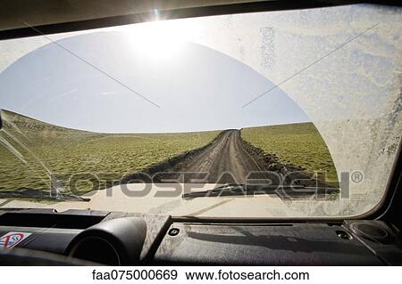 Iceland, Lakagigar, path through moss covered lava field, viewed through car windshield View Large Photo Image Stock Photo - Iceland, Lakagigar, path through moss covered lava field, viewed through car windshield. Fotosearch