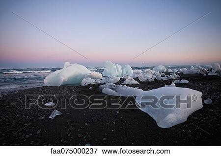 Stock Photo - Large pieces of glacial ice washed up on beach, Jokulsarlon glacial lagoon, Iceland. Fotosearch