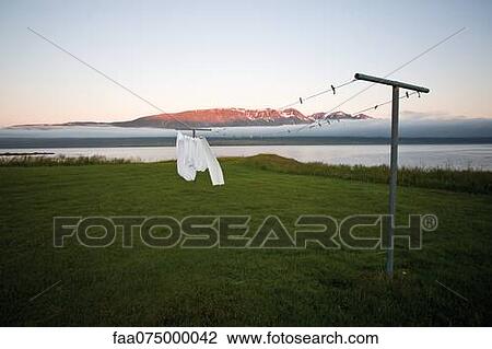 Laundry drying on clothes-line in remote landscape, Vopnafjordur, Iceland View Large Photo Image Stock Image - Laundry drying on clothes-line in remote landscape, Vopnafjordur, Iceland. Fotosearch