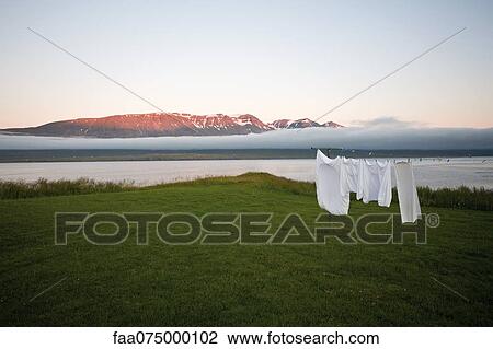 Laundry drying on clothes-line in remote landscape, Vopnafjordur, Iceland View Large Photo Image Stock Image - Laundry drying on clothes-line in remote landscape, Vopnafjordur, Iceland. Fotosearch