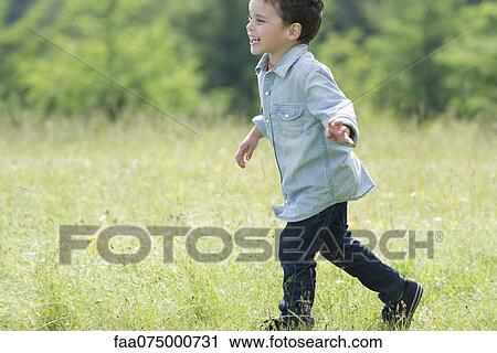 Little boy running in meadow, side view View Large Photo Image Stock Image - Little boy running in meadow, side view. Fotosearch