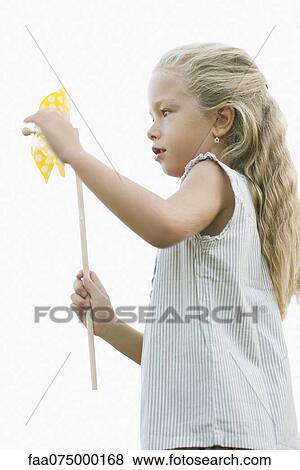 Stock Photo - Little girl holding pinwheel. Fotosearch