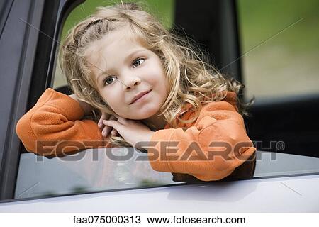 Little girl leaning out of car window, daydreaming, portrait View Large Photo Image Stock Image - Little girl leaning out of car window, daydreaming, portrait. Fotosearch