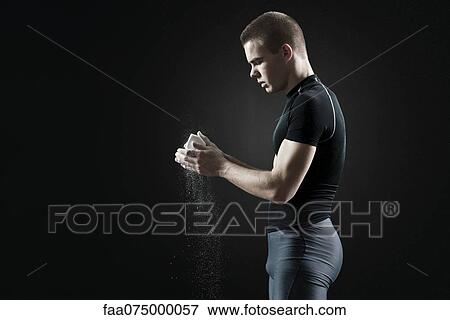 Male athlete applying chalk to hands View Large Photo Image Stock Photo - Male athlete applying chalk to hands. Fotosearch