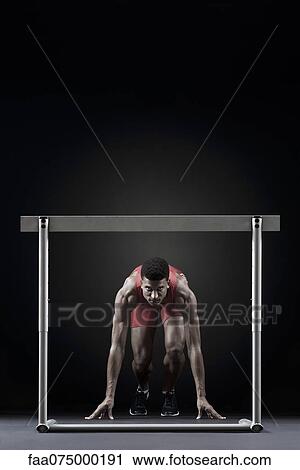 Male athlete at starting position in front of hurdle View Large Photo Image Stock Image - Male athlete at starting position in front of hurdle. Fotosearch