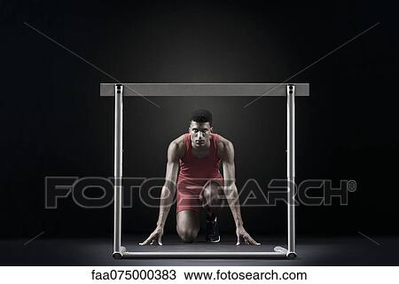 Male athlete at starting position in front of hurdle View Large Photo Image Stock Image - Male athlete at starting position in front of hurdle. Fotosearch