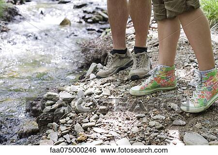Man and woman standing by stream, low section View Large Photo Image Stock Photograph - Man and woman standing by stream, low section. Fotosearch